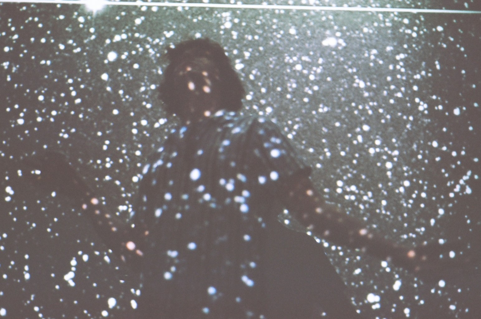 Robin Fisher surrounded by projected stars.
