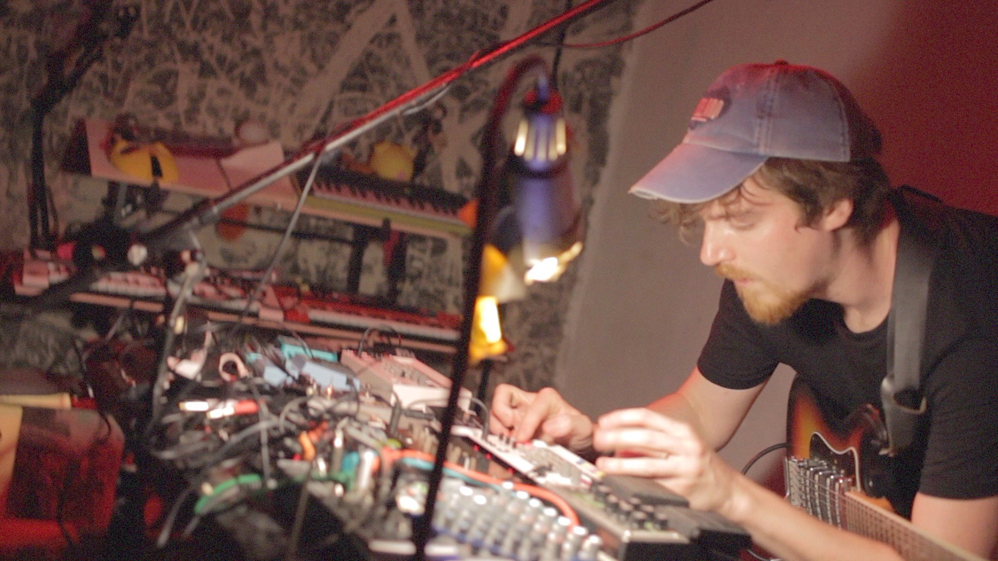 Robin Fisher working with electronic music equipment.